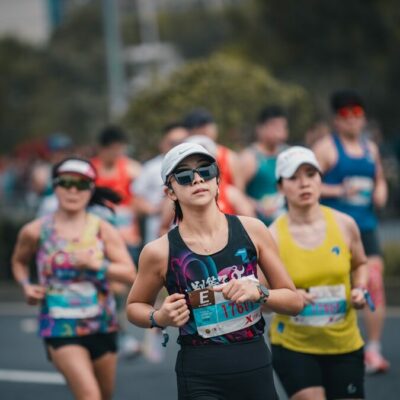 Women running in a marathon race outdoors.