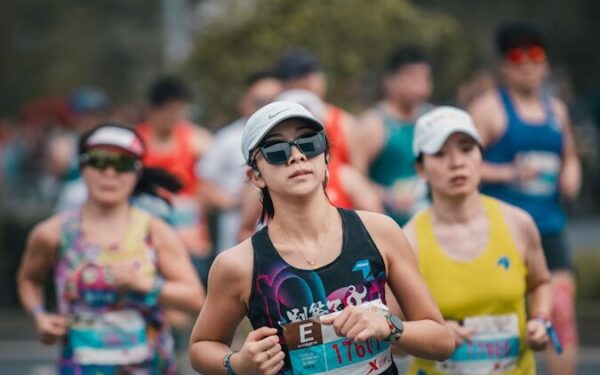 Women running in a marathon race outdoors.
