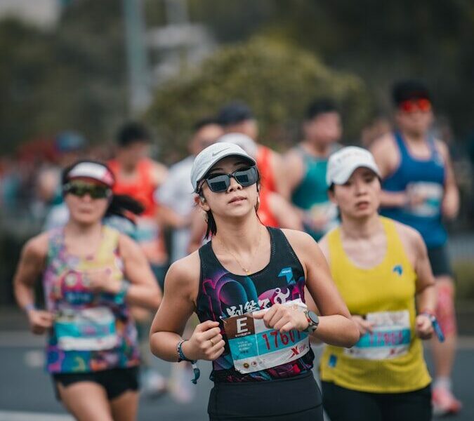 Women running in a marathon race outdoors.