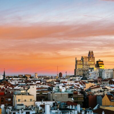 city with high rise buildings under orange and gray skies during sunset