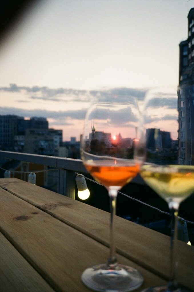 two glasses of wine sitting on a wooden table